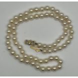 A radiant princess length strand of 5mm cream-white Akoya cultured pearls, linked by an 18 carat