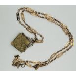 Unusual square shaped locket on razor blade style chain, containing antique photos of two young