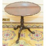 ***AWAY*** A Victorian mahogany tilt-top tripod table, raised pie crusted top, raised on a turned