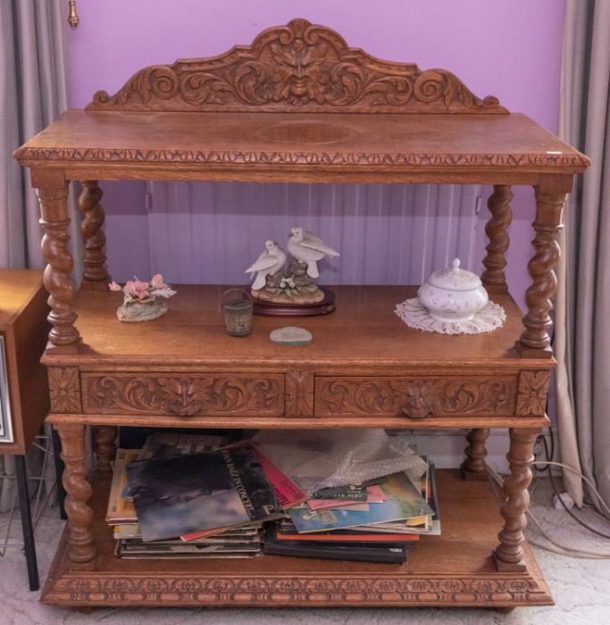 A Victorian carved golden oak buffet of three tiers and two drawers, 107cm wide