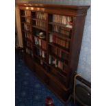 A late Victorian large walnut bookcase, with moulded cornice over three divisions enclosing