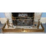 An early 19th century brass and wire mesh fire fender, a brass fire curb, a pair of brass andirons,