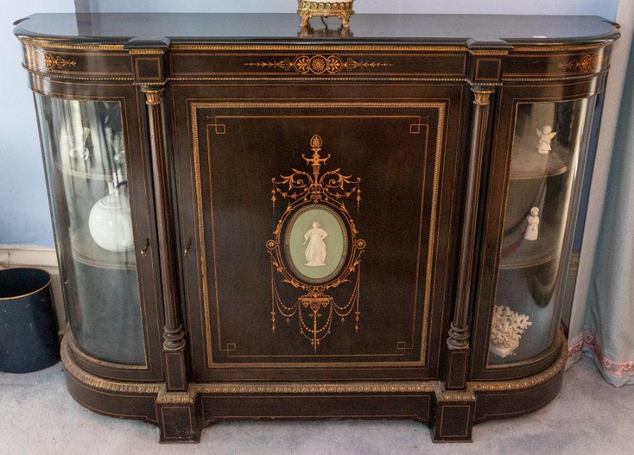 A 19th century ebonised, boxwood inlaid and ormolu mounted credenza, the central door with inset