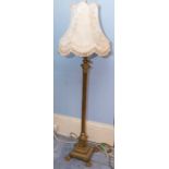 A late Victorian/Edwardian brass Corinthian column adjustable standard lamp with stepped base and