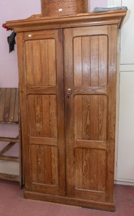 A late Victorian Oregon pine linen cupboard of two doors of three panels, 105cm wide