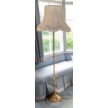 A late Victorian/Edwardian decorative brass adjustable standard lamp with domed and fluted base: