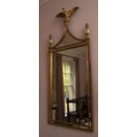 A pair of highly decorative reproduction Empire style gilt mirrors, each surmounted by an eagle and