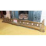 A late 19th century gilt brass and porcelain mounted neo-classical fire curb, of pierced scroll