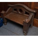 An oak hall bench in Arts and Crafts Style circa 1900, with generous seat, arched and pierced back,