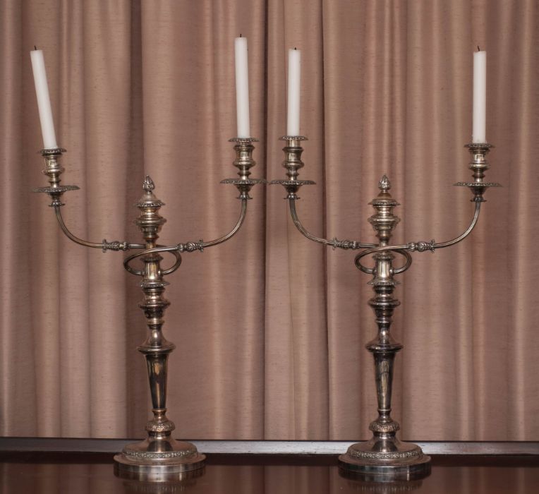 A large pair of Sheffield plate candelabra, 19th century, with weighted candlestick stems and a two