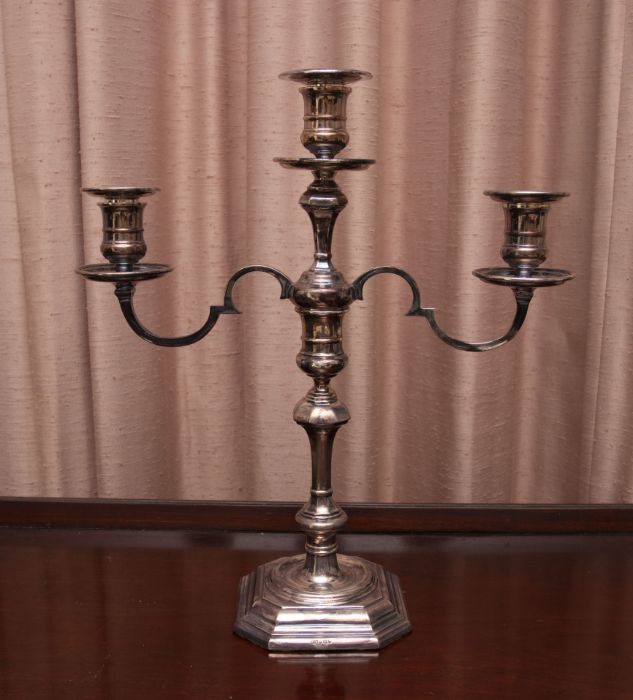 An Elizabeth II silver candelabrum, in George II style, with candlestick stem and two branch/three
