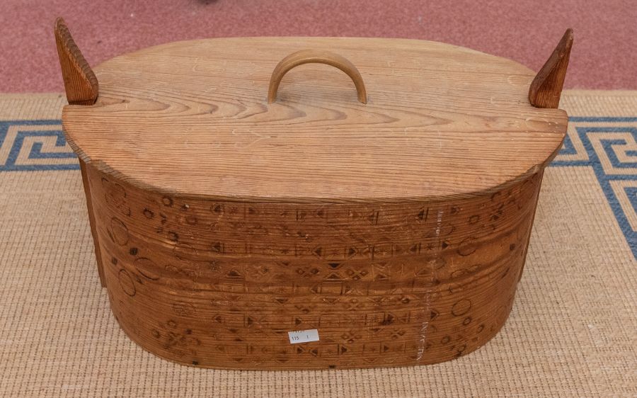 A Scandinavian pine and birch bark sandwich box with pokerwork folk motif details, 44cm wide (