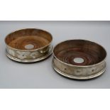 MC Hersey, a pair of silver 12.5cm diameter bottle coasters, each with turned wood base. London