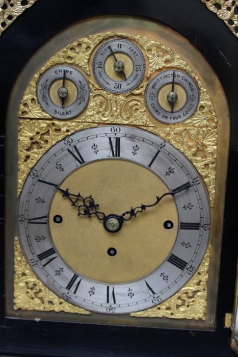 A large boardroom or table clock, in ebonised case adorned with gilded castings, with eight day
