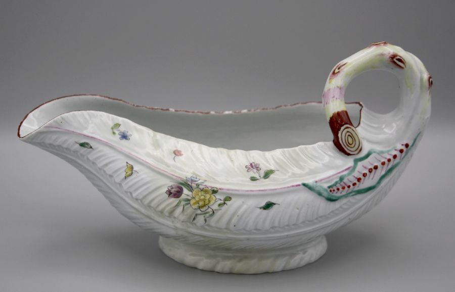 A mid 18th century Worcester leaf moulded sauce boat, polychrome decorated overglaze with floral