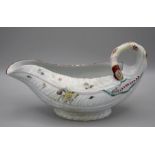 A mid 18th century Worcester leaf moulded sauce boat, polychrome decorated overglaze with floral