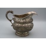 William Power, a George IV Irish silver cream jug, the florally embossed body with lion's mask
