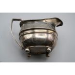 RK, a George III silver three piece tea set, each of rounded oblong shape, with gadrooned rim