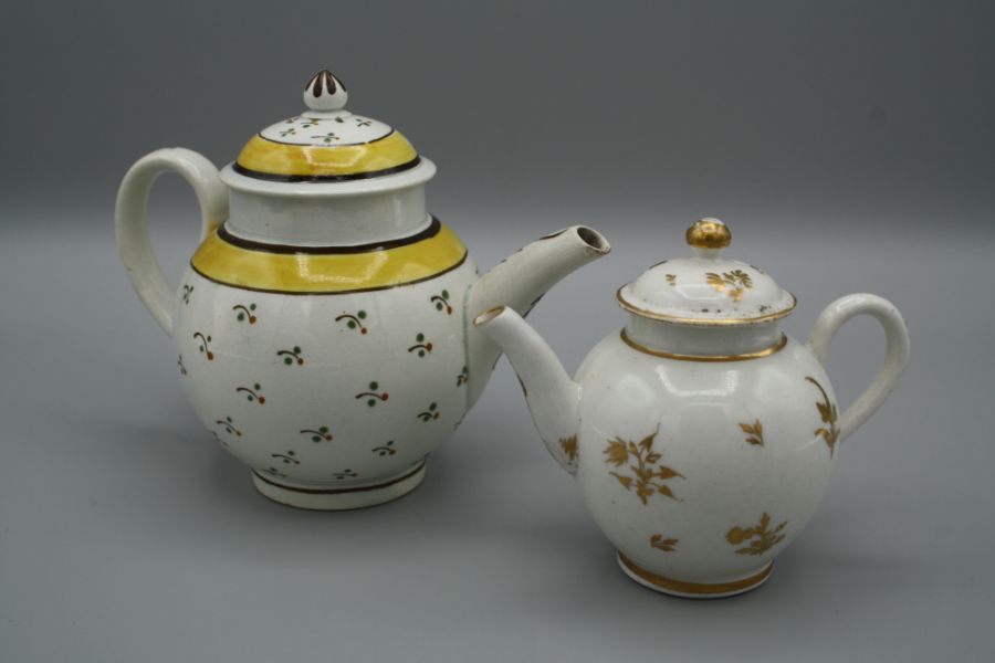 An 18th century Staffordshire creamware miniature teapot, polychrome decorated with floral sprigs