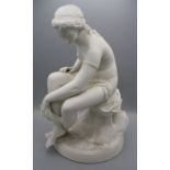 A 19th century English parian figure of a female nude, seated upon a rock, drying with a robe,