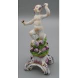 An 18th century Bow porcelain figure of a minor sea God, blowing a conch, on a puce shell applied