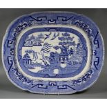 A large mid 19th century blue and white meat platter, printed with Willow pattern, 46 x 57cm