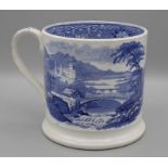 A mid 19th century English pottery mug, with flat strap handle and ogee foot, printed underglaze