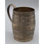 Samuel Meriton, a George III silver mug of reeded, ribbed barrel shape with elongated scroll handle.