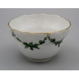 An 18th century Bristol porcelain tea bowl of twin ogee shape, decorated overglaze with green swags,