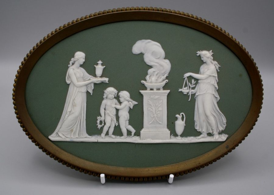 A 19th century Wedgwood green Jasperware plaque, decorated with classical female figures, putti