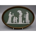 A 19th century Wedgwood green Jasperware plaque, decorated with classical female figures, putti