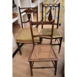 Three Edwardian bedroom chairs: two with inlaid back supports, the third with cane seat