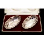 A pair of George V silver oval bon bon baskets, reticulated sides, hallmarked by A J Zimmermann,