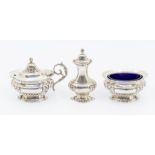 An early 20th Century silver condiment set comprising mustard pot & cover, salt and pepper, the salt