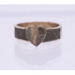 A Victorian mourning ring with heart front initialled L.G, woven hair to shoulders, size P11/2,