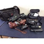 A collection of vintage cameras, video camera and binoculars