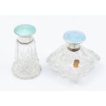 Two George V cut glass vari-shaped scent bottles with stoppers, each with silver and enamelled