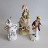 Three Staffordshire figures, a male musician playing lyre, standing on a scrolled base, along with a