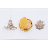 Two Royal Artillery sweetheart silver brooches along with yellow metal Axes watch pendant in the