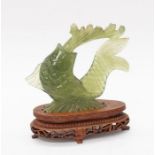 A jade Chinese Koy Carp, on a hardwood stand