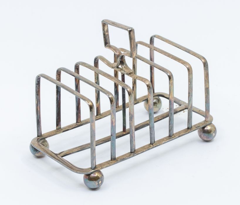 A Victorian silver seven bar toast rack, on four ball feet, hallmarked by Atkin Brothers, Sheffield,