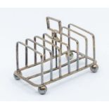 A Victorian silver seven bar toast rack, on four ball feet, hallmarked by Atkin Brothers, Sheffield,