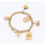 A 9ct yellow gold charm bracelet with padlock clasp, suspending five charms, total gross weight