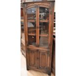 Mid 20th Century dark oak old charm glazed corner cupboard along with oak matching glazed bookcase