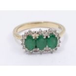 An emerald and diamond 9ct gold cluster ring, comprising three small clusters set in a row, claw set