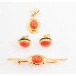 An 18ct gold, coral set pendant and earrings together with a yellow metal bar brooch also set with