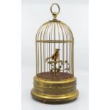 An early 20th Century German gilt metal bird cage automaton, with yellow bird perched with
