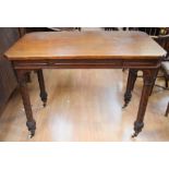 A Victorian oak library table, circa 1870, over-hanging top, moulded frieze and fitted with a frieze