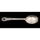 An Arts & Crafts large serving spoon, planished / hammered bowl, tapering stem with ornate pierced
