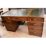 Reproduction mahogany desk with four drawers either side of central drawer, green leather inserts,